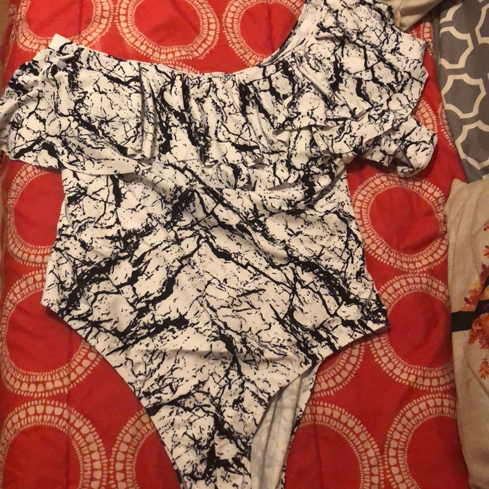 White and black one shoulder swimsuit with fringe